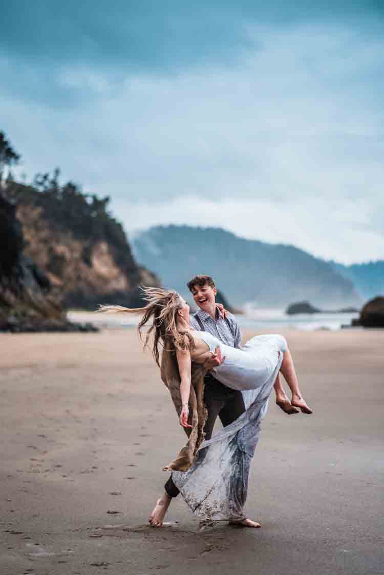 A groom carrying a bride on the beach