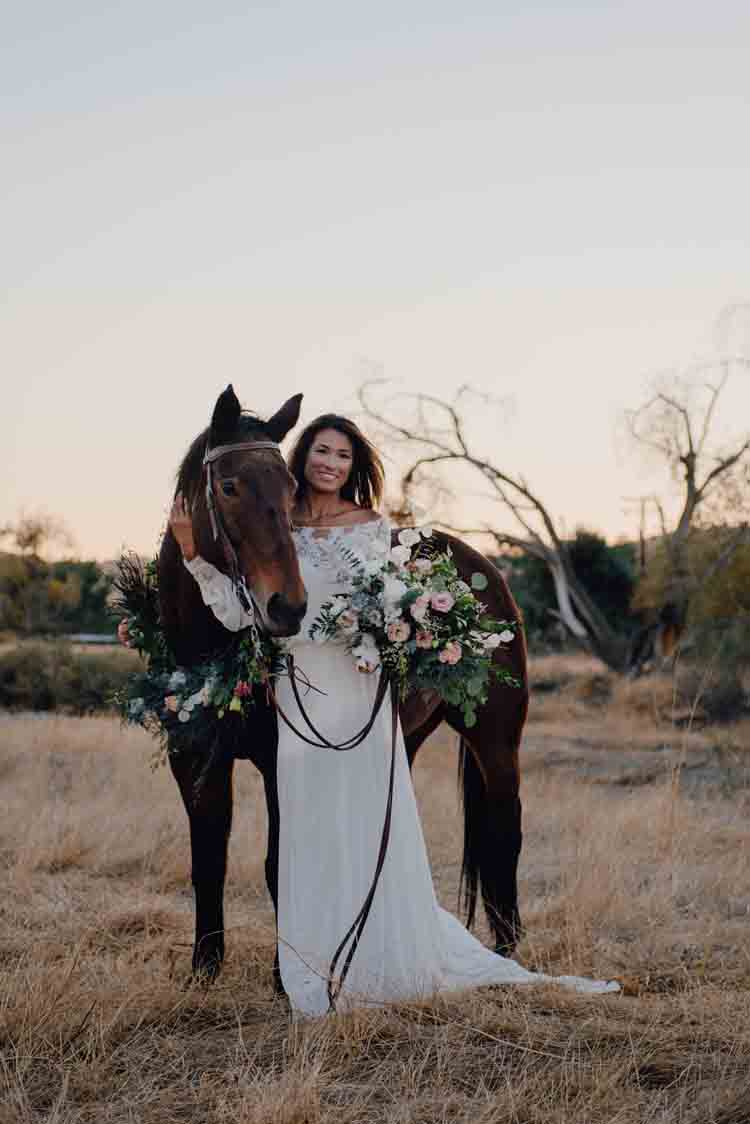 A bride standing next to a horse