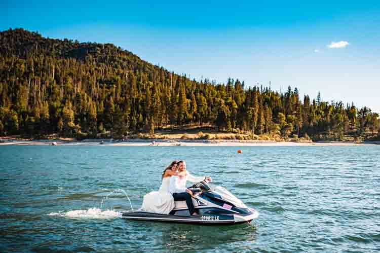 A bride and groom on a lake on a jetski