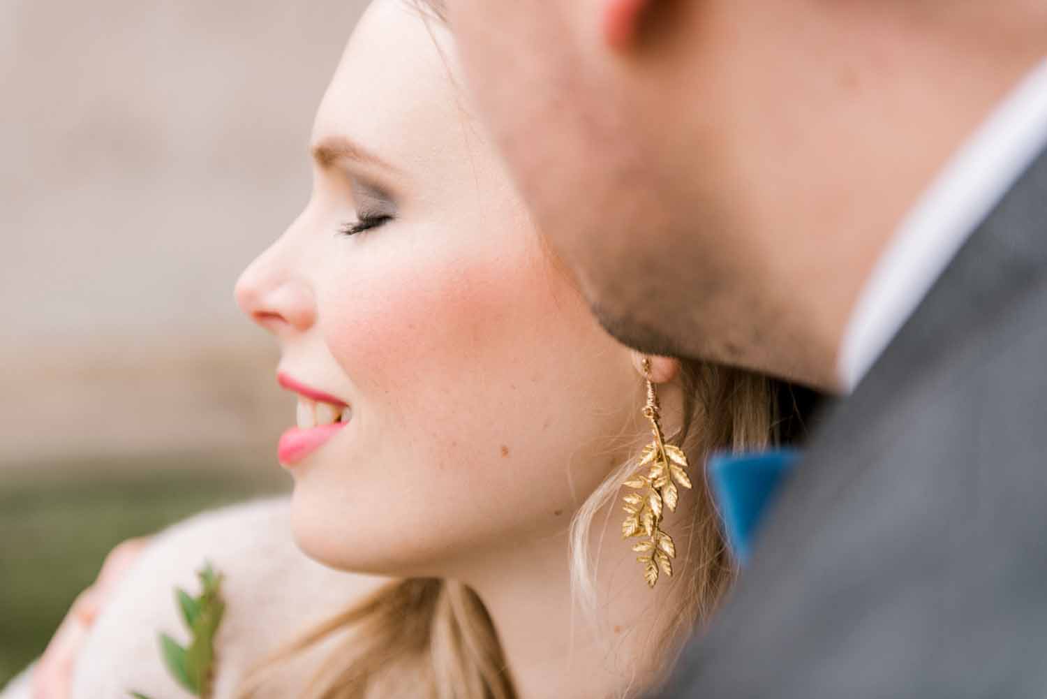 side profile of woman smiling with her eyes closed during her Paris engagement celebration