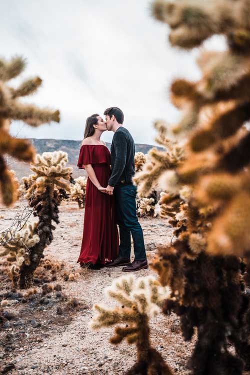 A bride and groom kissing during an elopement in the desert