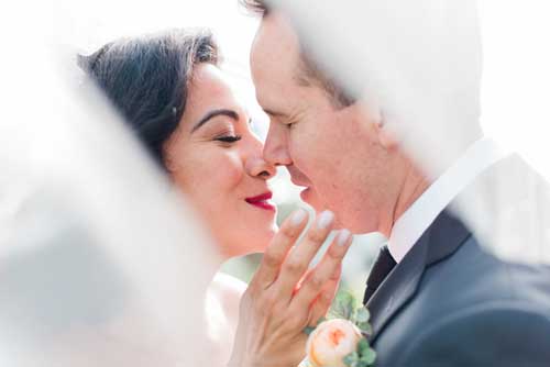 A bride and groom about to kiss during an elopement