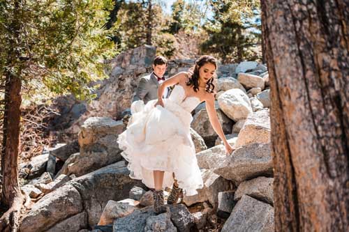 A couple stepping through rocks during a lake tahoe elopement